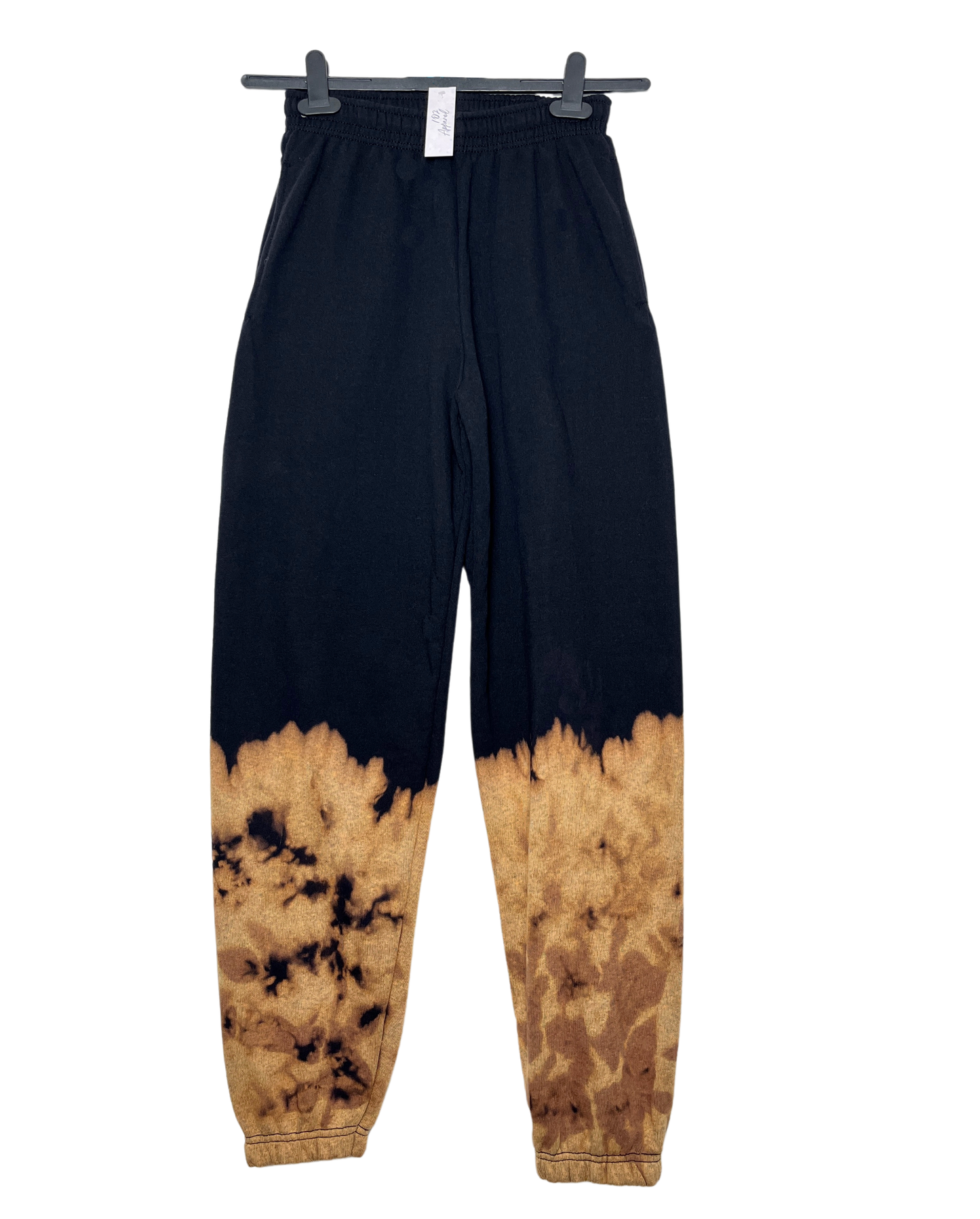 Black sweatpants with bleach dip dye at the ankles creating an orange firey effect