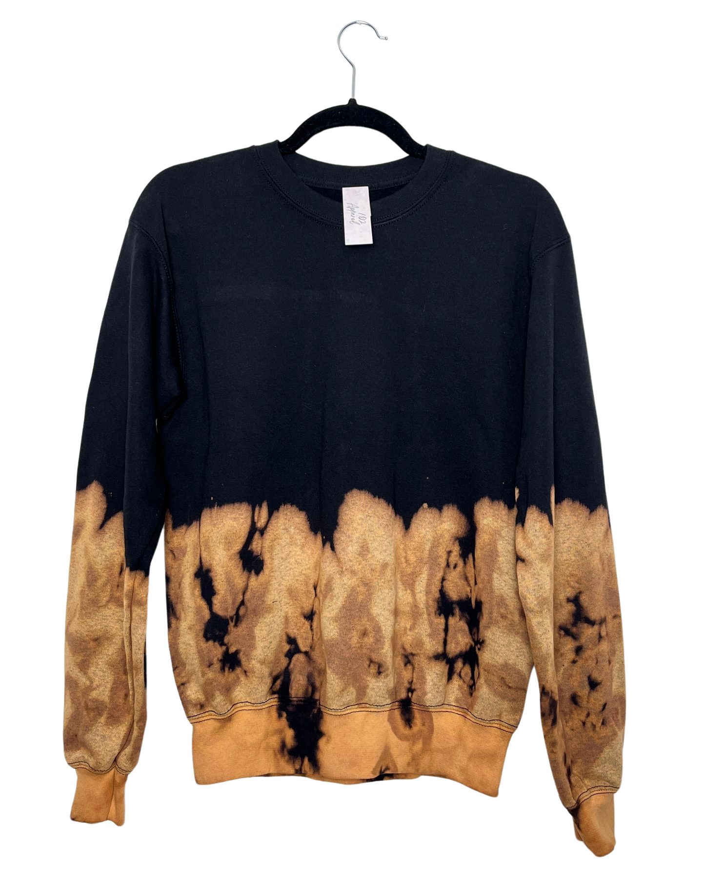 a black crewneck sweatshirt dip dyed with bleach on bottom third of the sweatshirt, creating a funky crumply effect