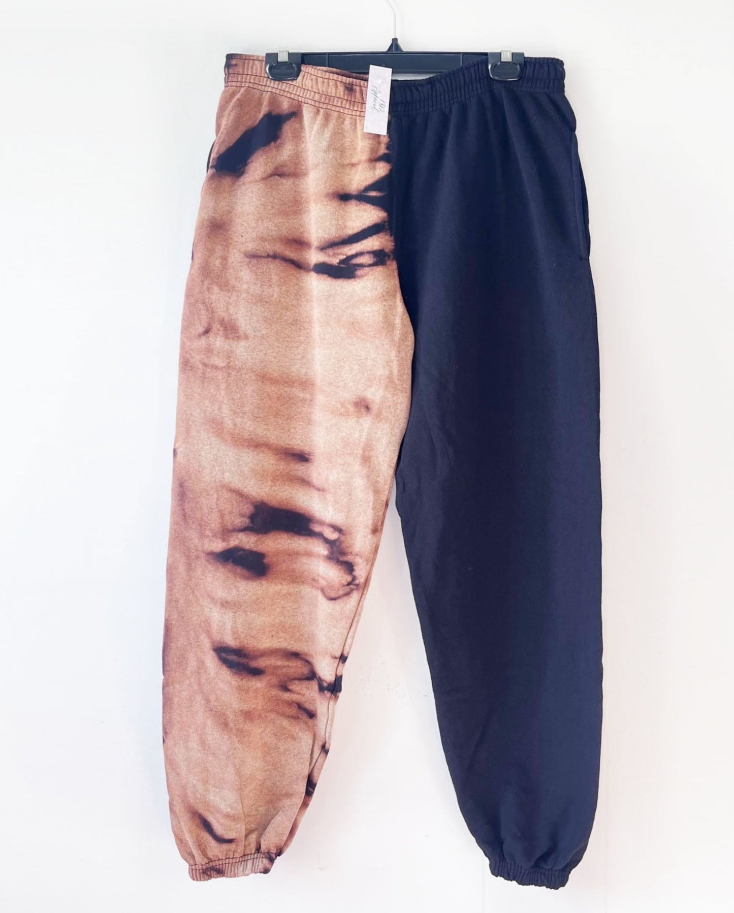 black and orange bleach tie dye sweatpants one leg bleach the other black