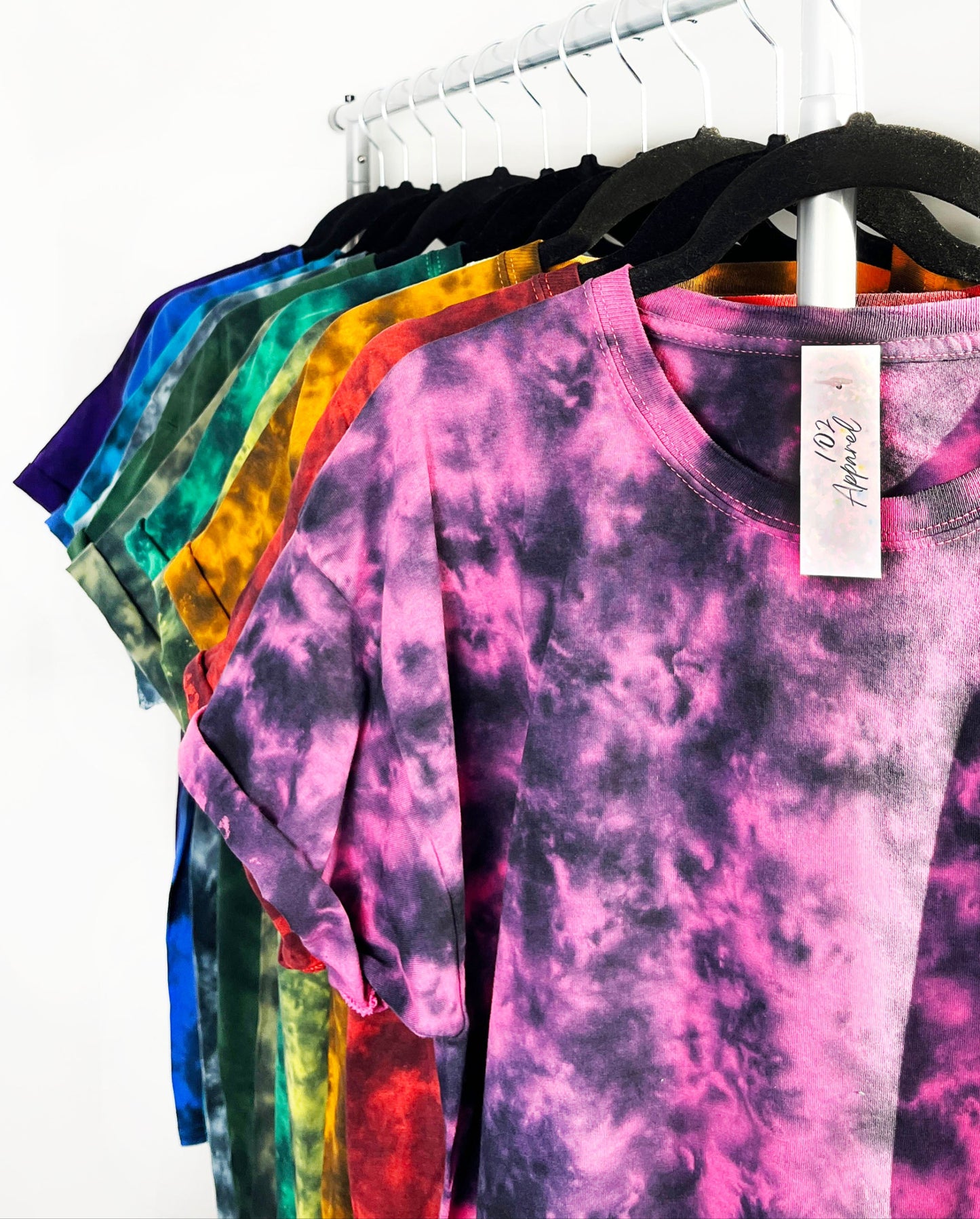a collection of coloured crewneck t shirts with black pattern