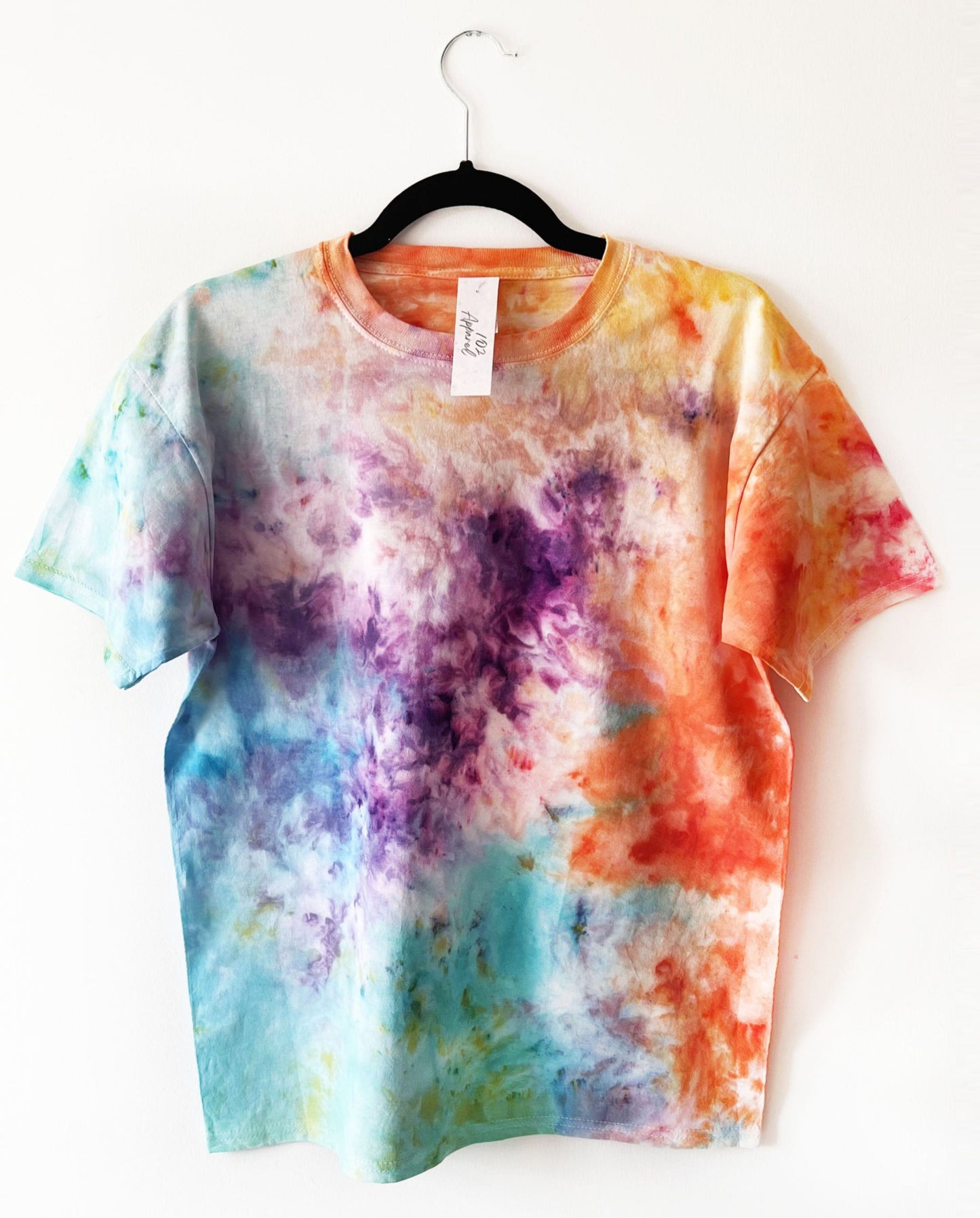 a crewneck t shirt tie dyed with colours inspired by the malibu rising book cover