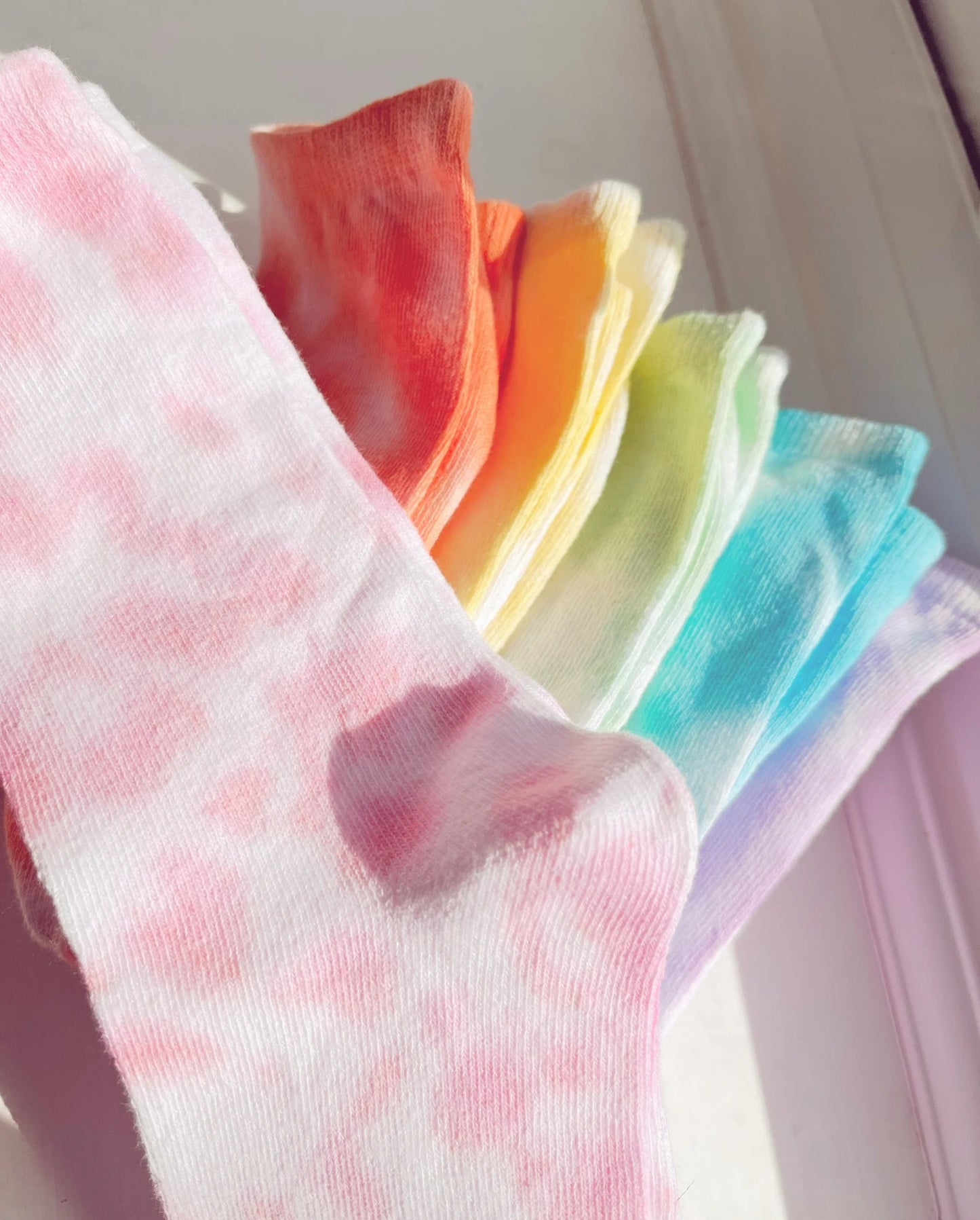 multiple pairs of socks in rainbow colours
