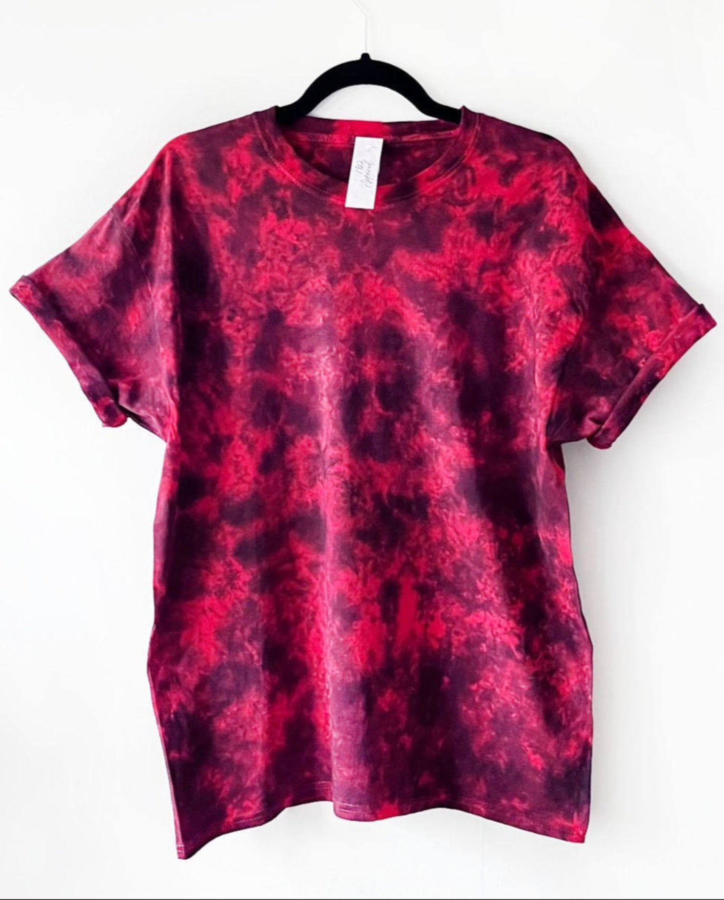 a red crewneck t shirt with a black dyed crumple effect