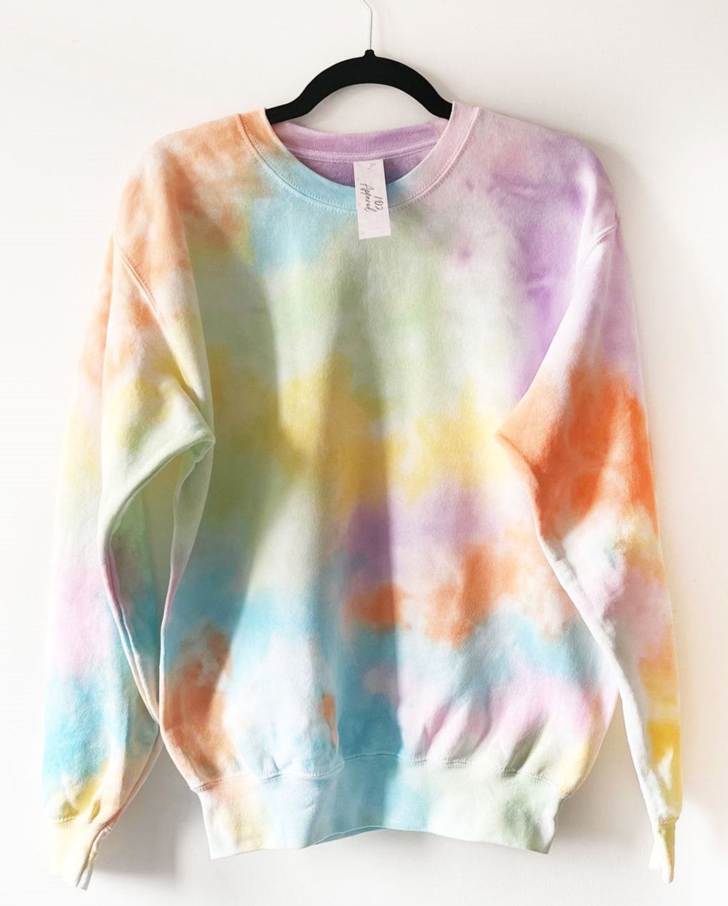 a crewneck sweatshirt with pastel rainbow colours, blended into an all over print