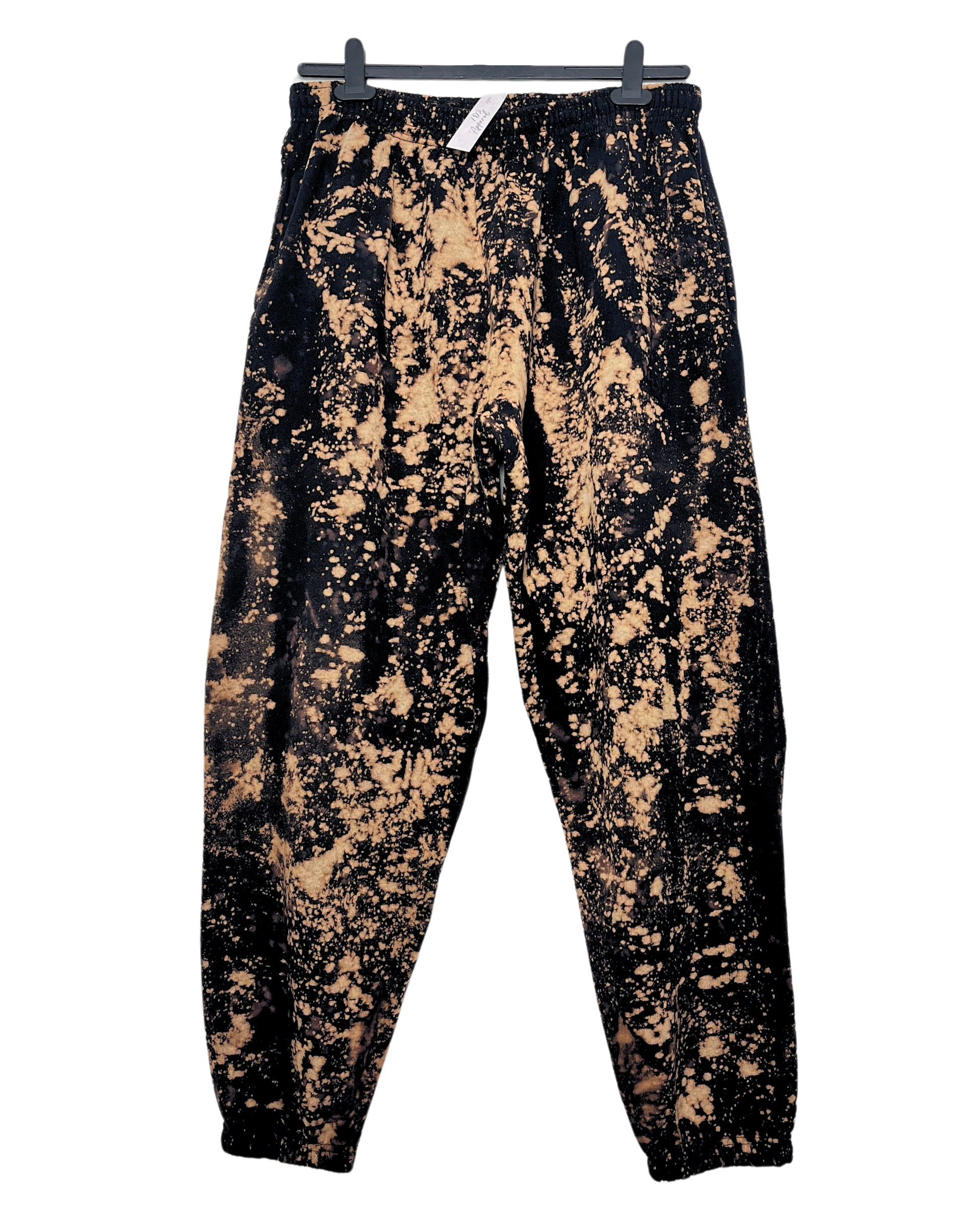a pair of black joggers sweatpants with bleach paint splatter effect pattern