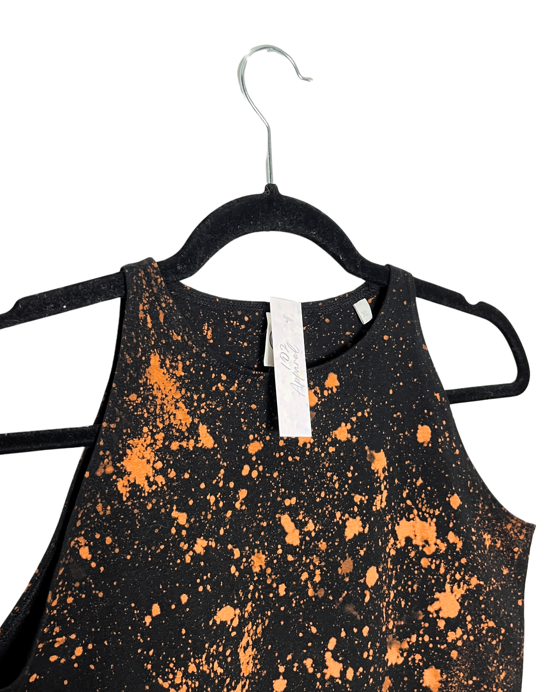 A black racerback crop top with paint splatter effect bleach orange pattern