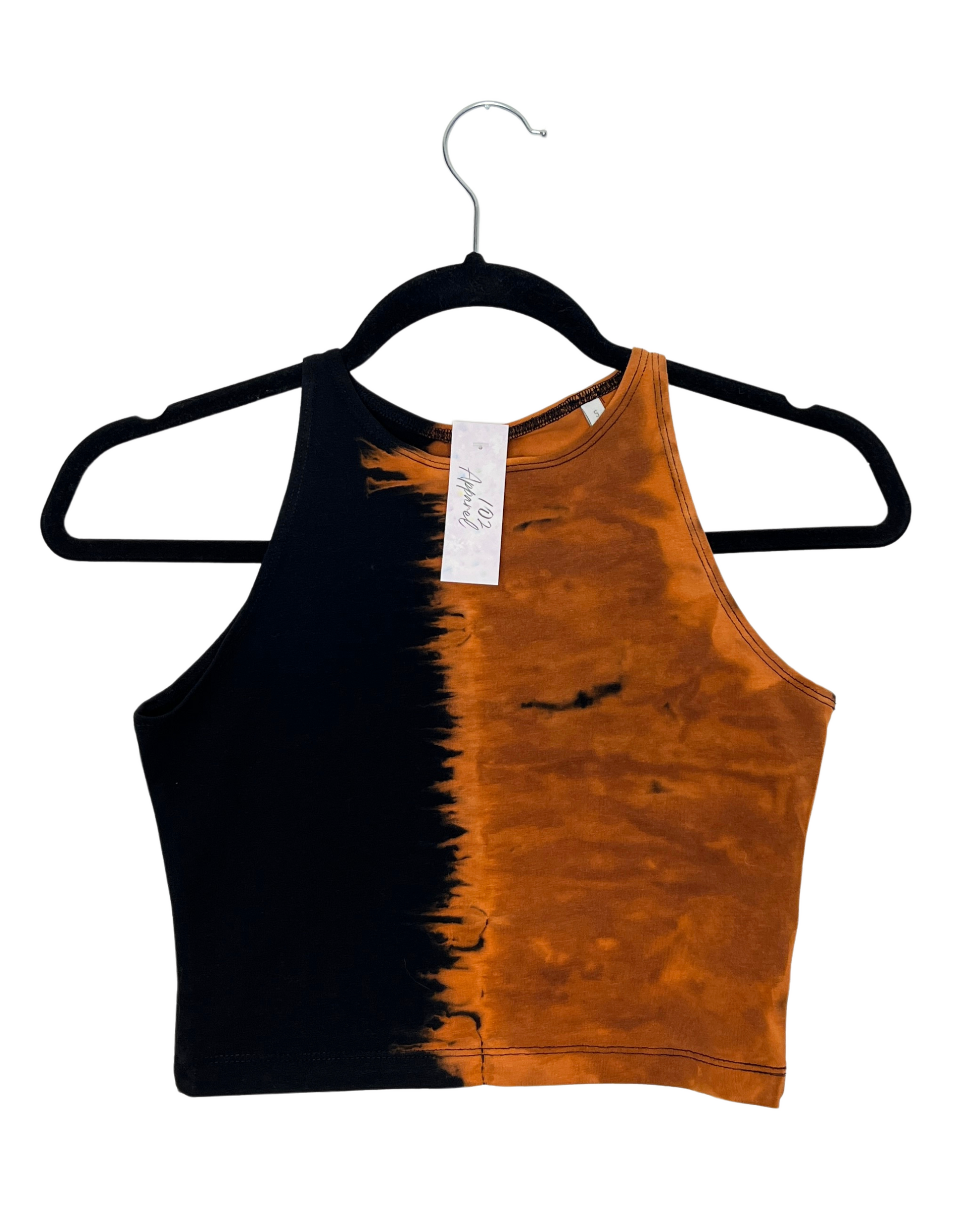 a racerback crop top with one side black and the other side bleach tie dye orange