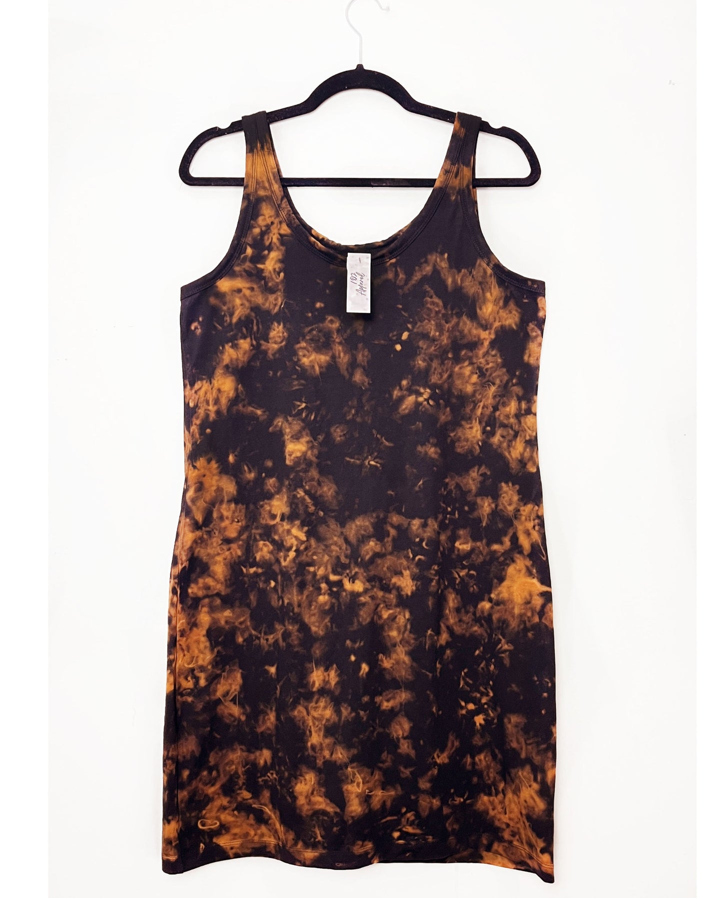 a black strappy dress in a tank top style with orange bleach tie dye pattern