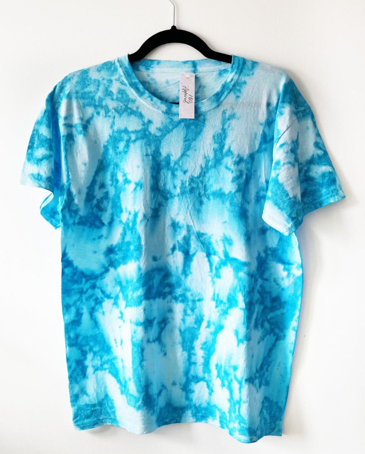 a white crewneck short sleeve t shirt with blue crumple sea foam like pattern
