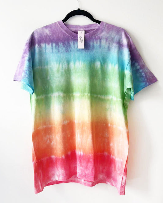a crewneck t shirt with rainbow tie dye design, purple at the top in block colours of the rainbow to red and the bottom